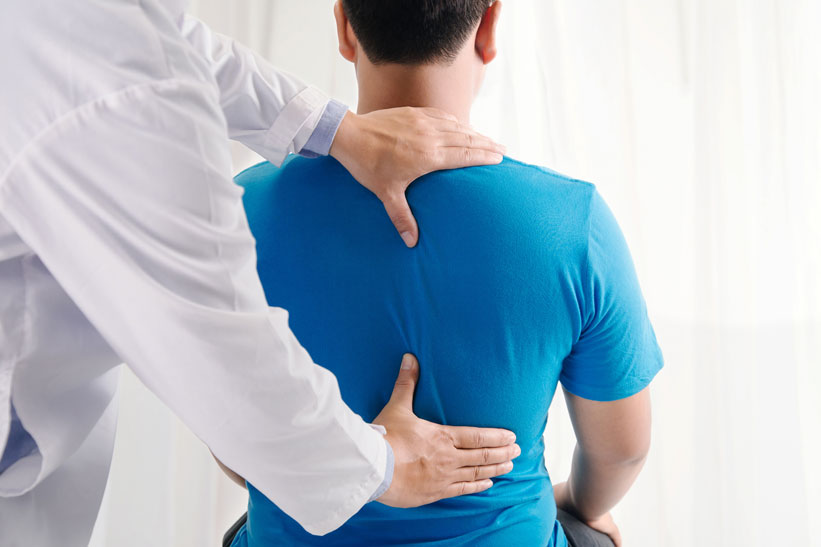 chiropractor adjusting back